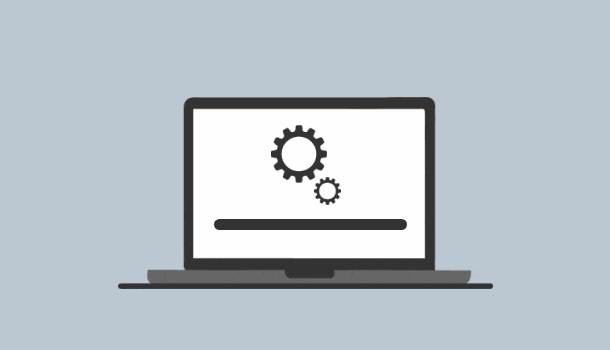 A laptop with a turning cog icon.