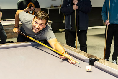 Rob playing pool at social event