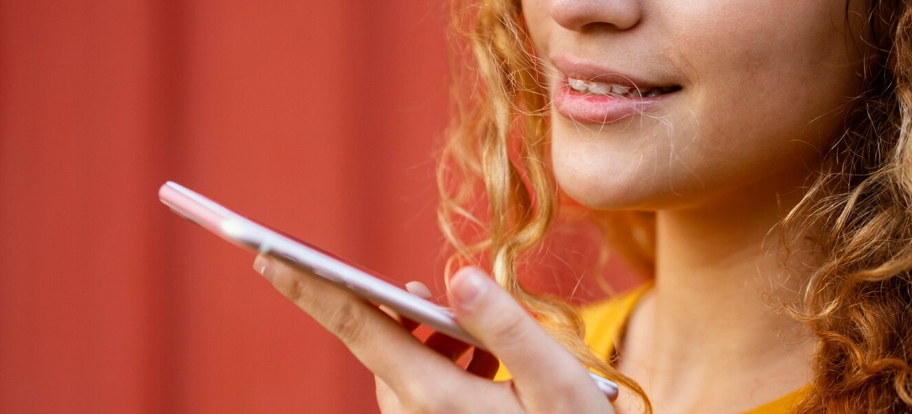 female talking into mobile device