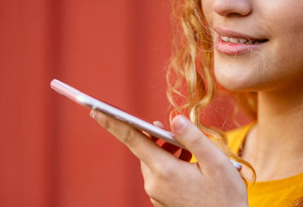 female talking into mobile device