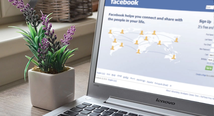 Facebook's sign up page, shown on a laptop.