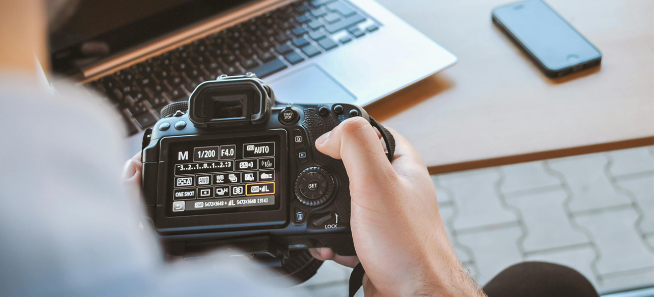 photographer checking an image on small digital camera screen