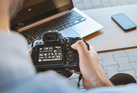 photographer checking an image on small digital camera screen