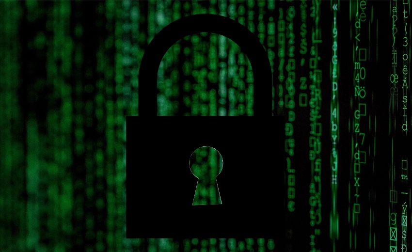 A dark padlock in front of a slanted wall of text and symbols representing code. The code is in vertical columns fading dramatically into the background.