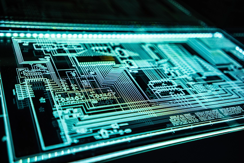 Bright blue lines, similar to a motherboard, are lit up against a dark background illustrating different circuit connections and the core of programs.