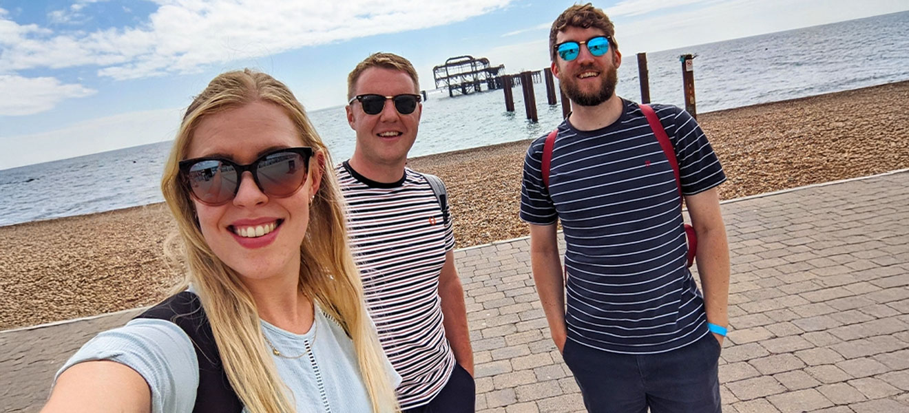 Team member selfie with Brighton West Pier in the background.