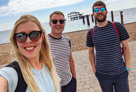 Team member selfie with Brighton West Pier in the background.