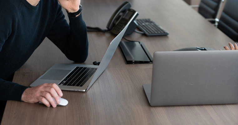 Laptops and other technology equipment on a desk, representing accessibility testing tools.