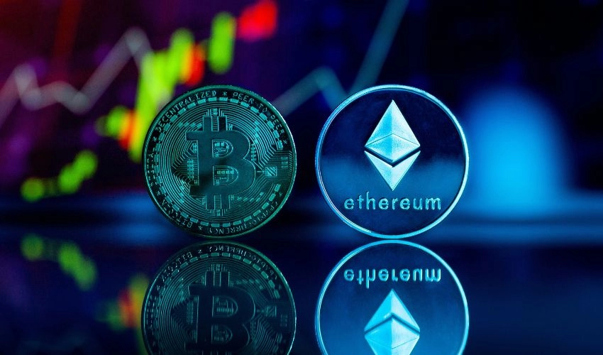 A digitally-created image visualises Bitcoin and Ethereum cryptocurrencies as holographic coins with the stock market in the background.