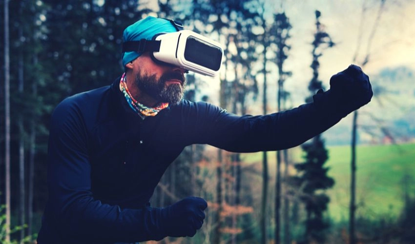 A photo of a man using a virtual reality headset, wearing a specially created virtual simulation suit.