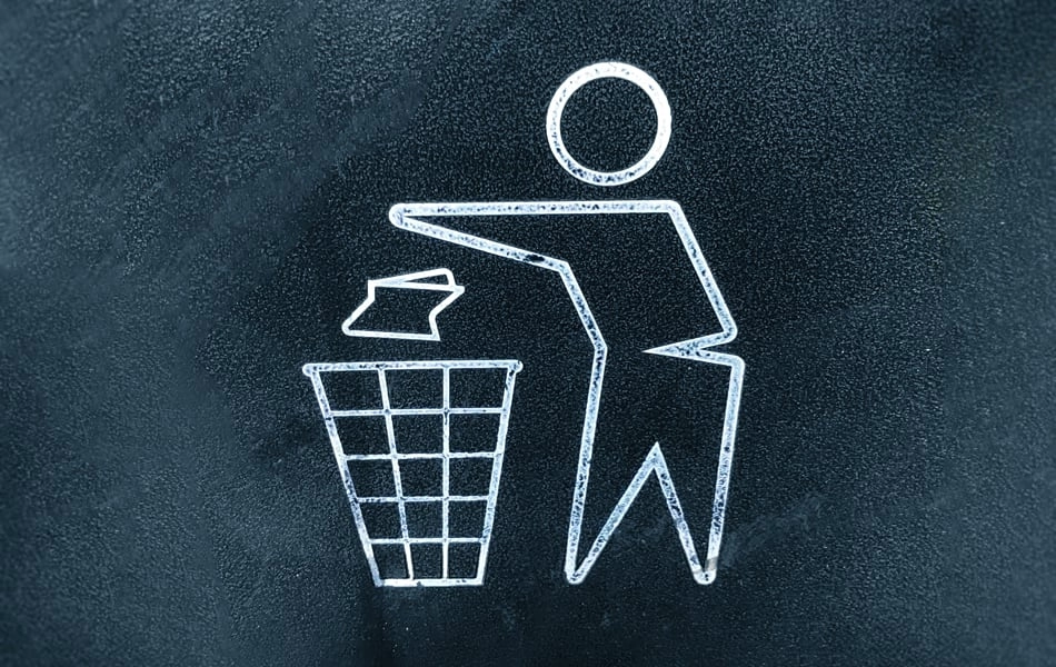 A painted recycle emblem shows a stick man dropping a piece of paper into a bin.