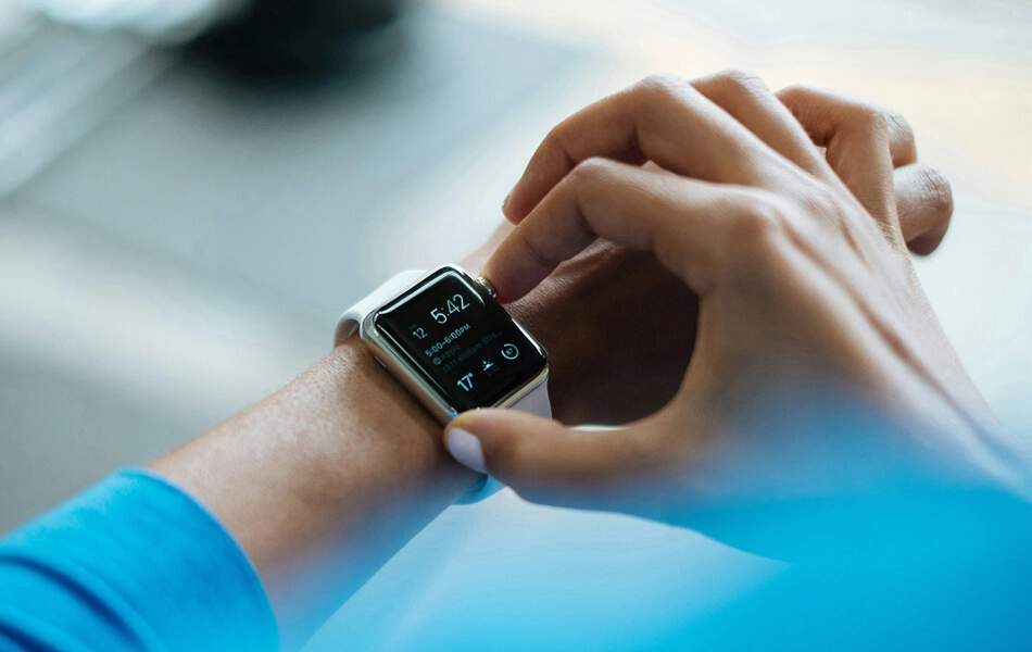 An athlete checking their health data on a smart watch after a jog.