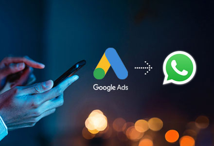 Using a mobile next to the Google Ads and WhatsApp logos.