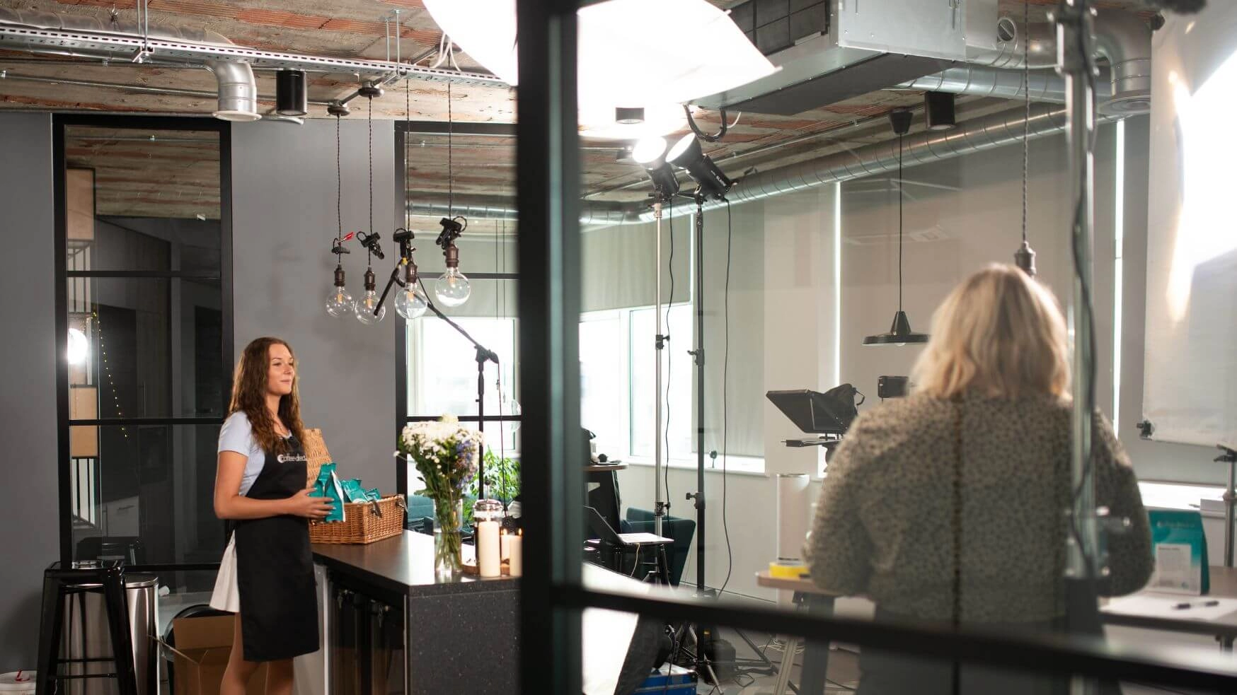 Wide view of a woman presenting to a camera.