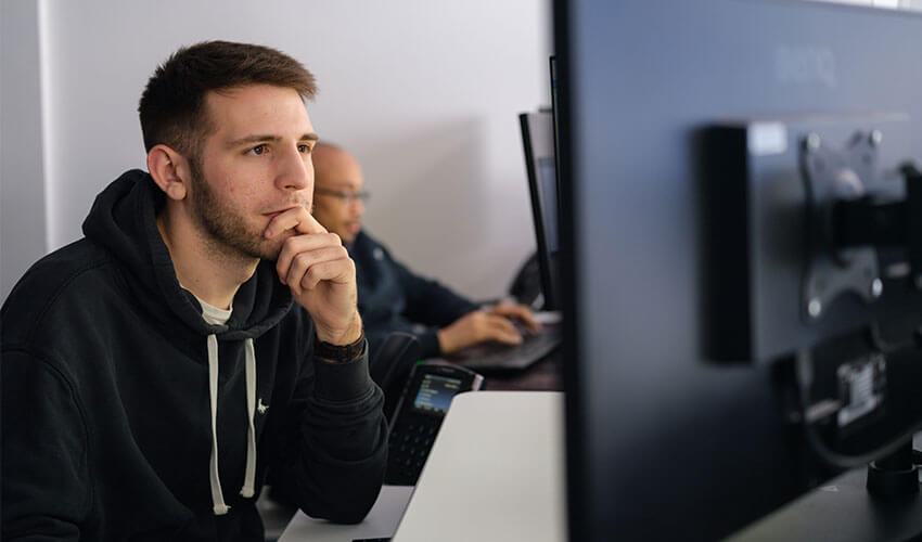 Jason looking at a monitor screen.