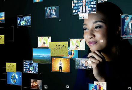 a glamorous woman watching multiple videos at once on a futuristic screen