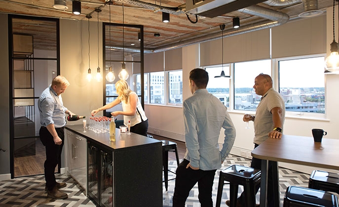 Pouring drinks in the Southampton office kitchen.