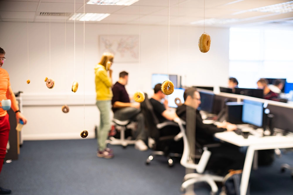 Doughnuts dangling in the office.