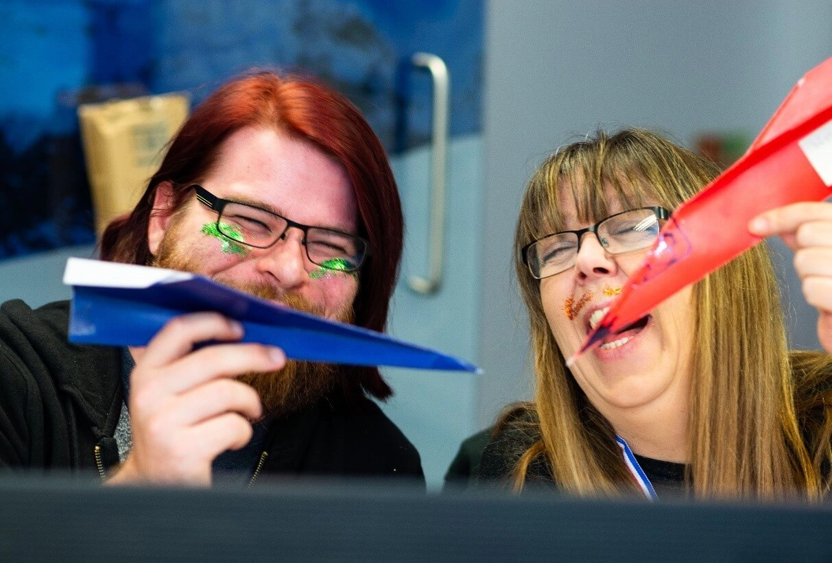 Seth and Amanda with paper aeroplanes.