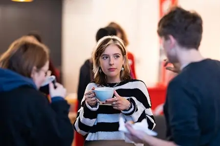 People drinking hot drinks at Go Digital.