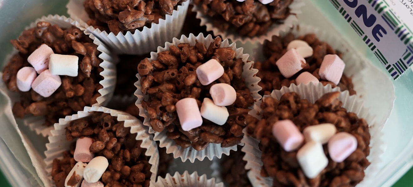 Chocolate crispy cakes with mini marshmallow decorations.