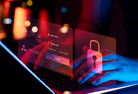 Typing on a laptop with a red overlay of a login screen and padlock icon.