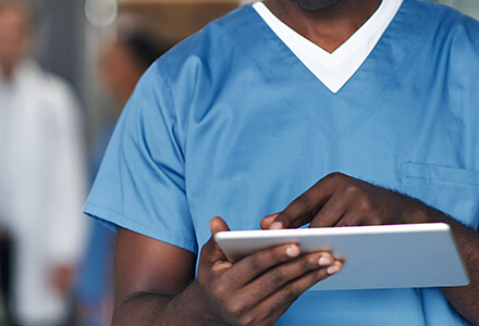 Medical staff using a tablet.