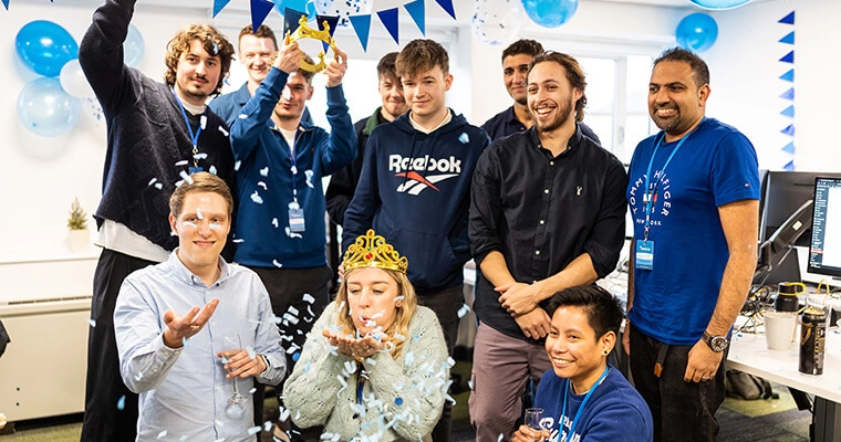 The team celebrate the new Bristol office opening day with blue bunting and confetti