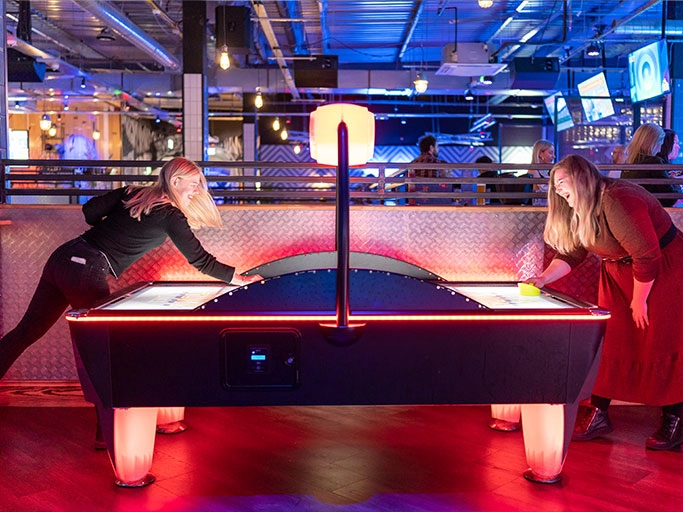 Bristol social playing air hockey.