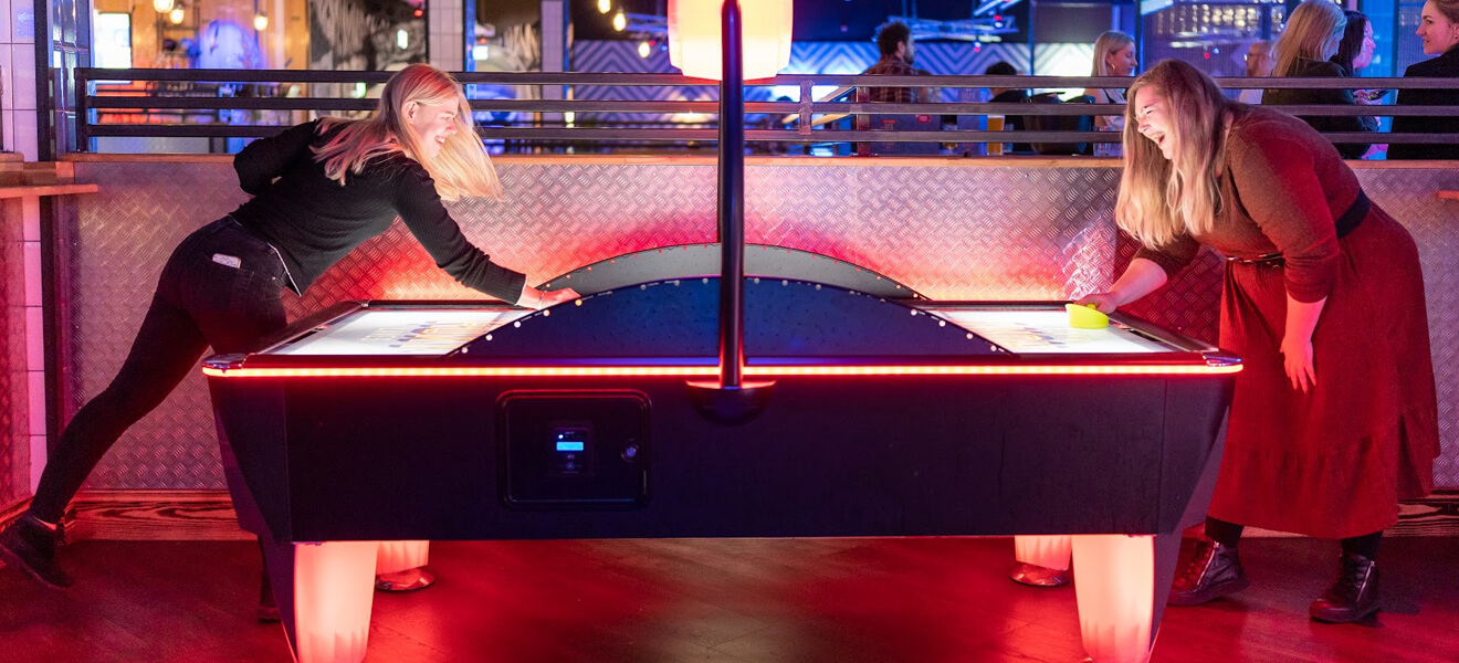 The team playing air hockey.