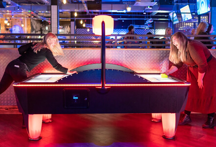 The team playing air hockey.