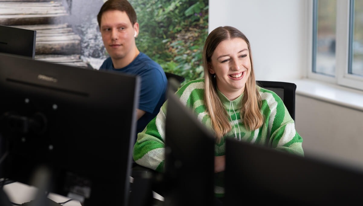 two colleagues working together and smiling