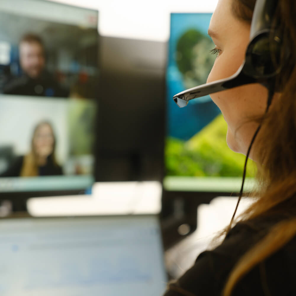 a person wearing a headset participating in an online video call a person wearing a headset participating in an online video call