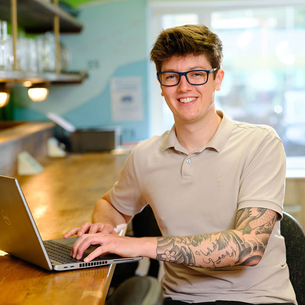 Kian working on his laptop